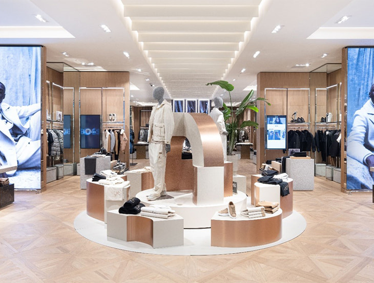 HUGO-BOSS store with shelves and products, styled in a warm, golden-bronze tone (photo)
